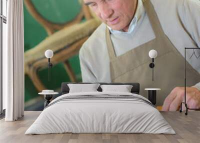 furniture maker chiselling a chair joint in his workshop Wall mural