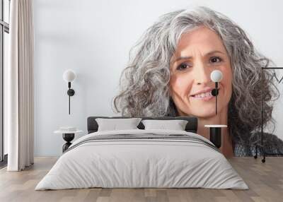 Grey-haired woman on white background Wall mural