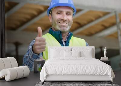 handsome construction worker showing thumb up Wall mural