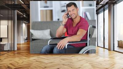 handsome man in wheelchair talking on his phone Wall mural