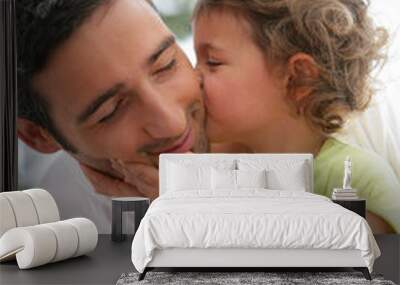 little girl kissing her father Wall mural