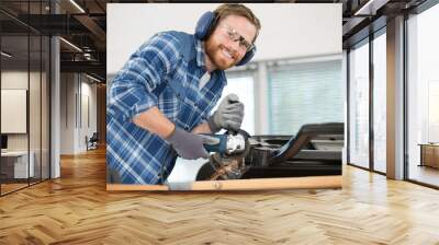 maintenance man using a power saw to fix metal sheet Wall mural