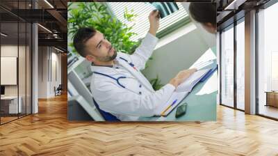 male radiologist talking to patient about an x-ray Wall mural