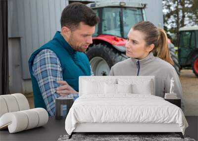 man and woman on farm looking at digital tablet Wall mural