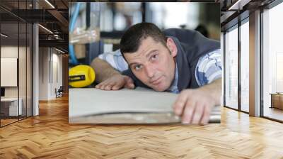 man controlling hydraulic press machine for cutting steel Wall mural