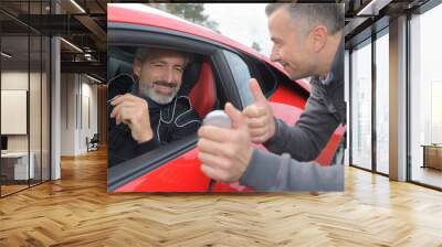 Man giving thumbs up to rally driver Wall mural