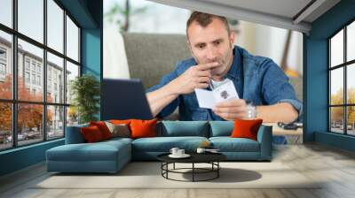 man looking for device manual on internet Wall mural