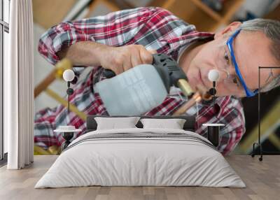 man using a blowtorch with cooper pippes Wall mural