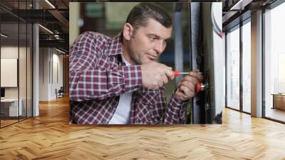 man worker screws metal frame Wall mural