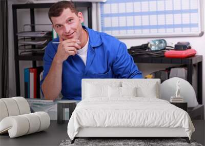 Manual worker looking at paperwork Wall mural