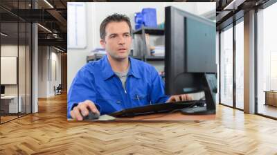 manual worker sat at his desk Wall mural