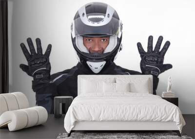 motorcyclist wearing black jacket, gloves and helmet Wall mural