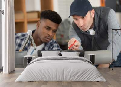 plumber preparing to saw through grey plastic pipe Wall mural