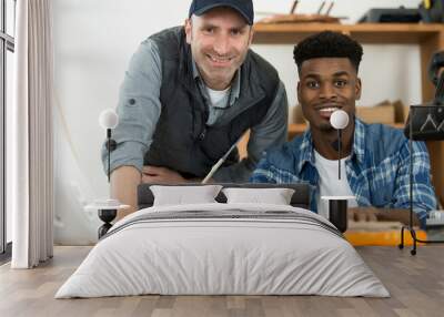 portrait of a happy teacher and apprentice smiling at camera Wall mural