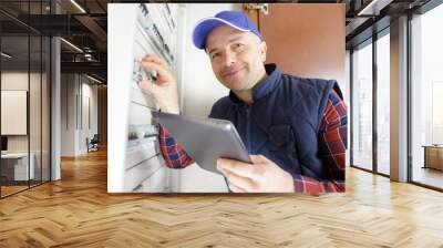 portrait of electrician standing next to fuseboard Wall mural