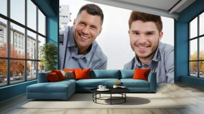 portrait of electrician with apprentice looking at the camera Wall mural