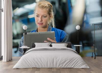 portrait of female factory worker using digital tablet Wall mural