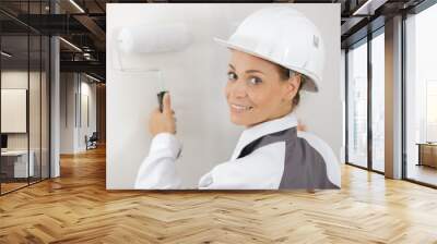 portrait of female painter and decorator using a roller Wall mural