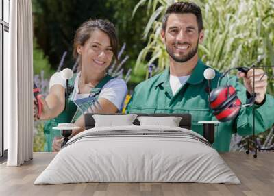 portrait of landscape gardening team holding tools of the trade Wall mural