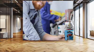 portrait of male operative working with factory equipment Wall mural