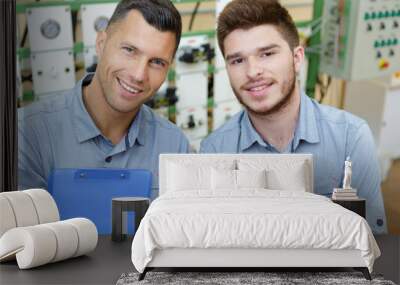 portrait of two men working in a workshop Wall mural