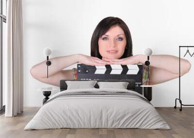 Relaxed woman leaning on a cinema clap on white background Wall mural