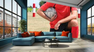 rugby player holding ball Wall mural