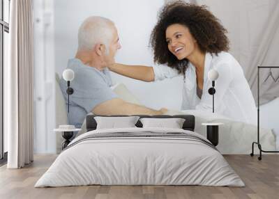 senior patient receiving help from female nurse Wall mural