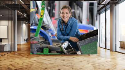 smiling woman in a mechanical workshop Wall mural