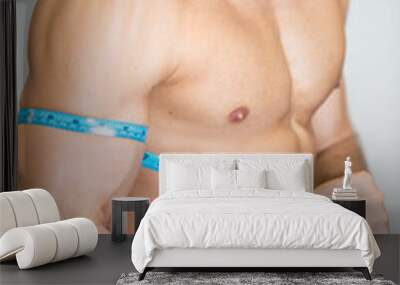 strong guy is feeling delighted while estimating his muscle size Wall mural