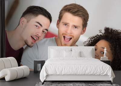 three young people singing into microphone Wall mural