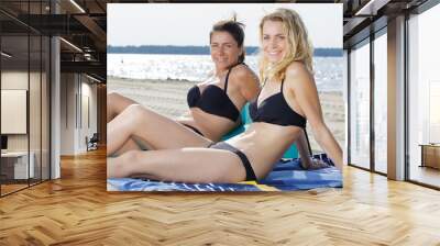 two beautiful young girlfriends at a sea cost Wall mural