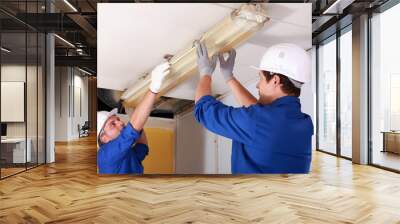 Two electrician repairing office lighting Wall mural