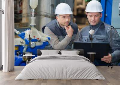 two foreman working with laptop in factory Wall mural