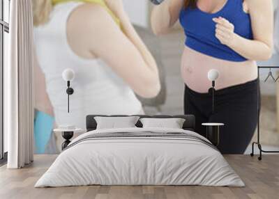 two happy pregnant women drinking water after exercising Wall mural