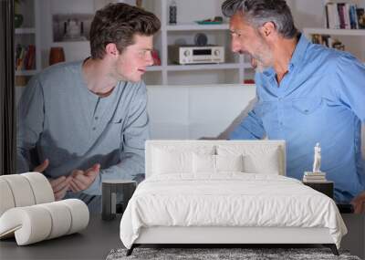 Two men at home arguing Wall mural