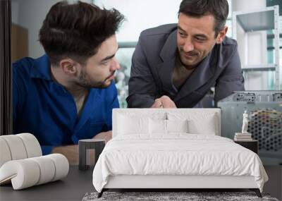 two men repairing hardware equipment from pc Wall mural