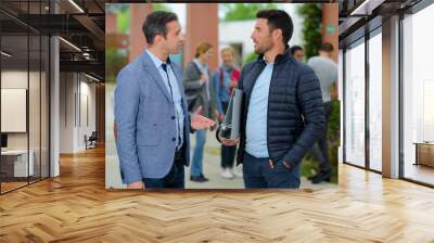 two men talking outdoors Wall mural