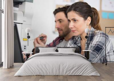 woman calibrating printer while working in nice printing office Wall mural