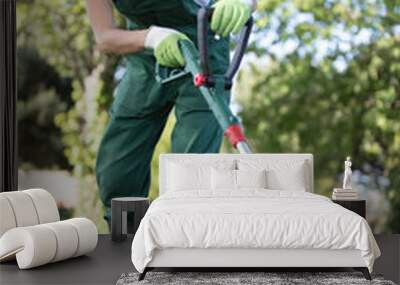 woman gardener in uniform mows the grass trimmer Wall mural