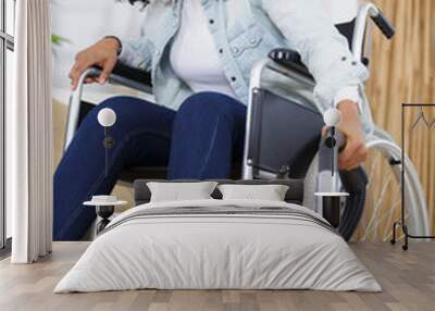 woman in wheelchair with vacuum cleaner Wall mural