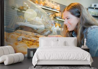 Woman pointing at bakery display Wall mural