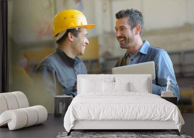 workers talking and laughing at a factory Wall mural