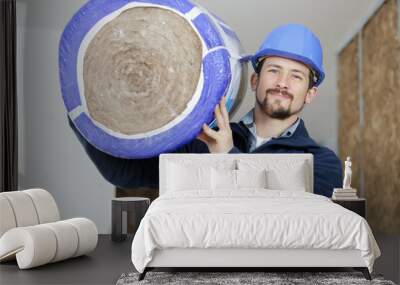 workman carrying a roll of insulation Wall mural