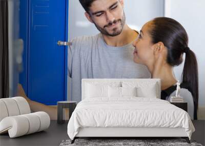 young man and woman flirting in the locker room Wall mural