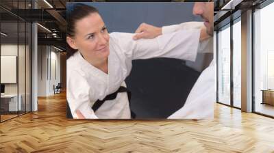 young woman and man judo fighters in sport hall Wall mural