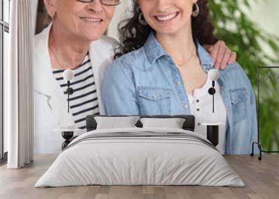 Young woman ironing for an elderly lady Wall mural