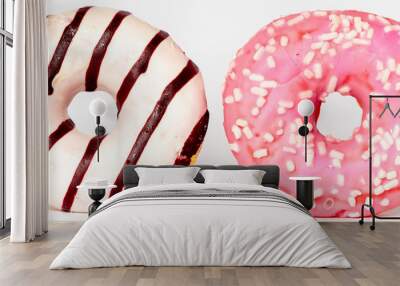 two donuts isolated on a white background, one pink with white sprinkles and the other one with strips of white and dark chocolate Wall mural