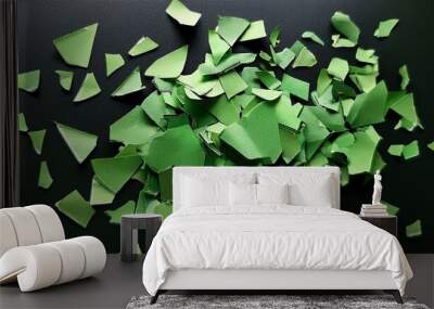 a scattering of green paper fragments on a dark surface a visual representation of discarded thoughts or unfinished ideas Wall mural