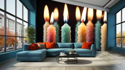 Candles glowing in the dark, capturing the warm light and anticipation of a birthday wish. The contrast between the bright candles and dark background creates a festive and elegant atmosphere. Wall mural